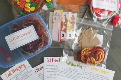 Lots of fall crafts in bags or containers and cards that have instructions, labeled Leaf Wrapping, Letter Harvest, etc.