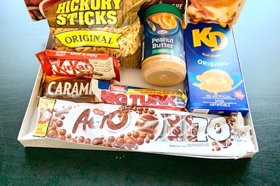 Items from a Canadian Snacks Food subscription box including Aero candy, KitKat, macaroni and cheese and peanut butter.