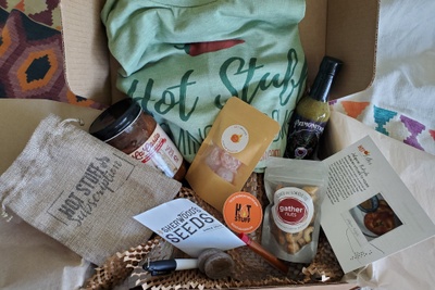 Spring box filled with spicy goods to celebrate growing season. Box includes hot sauce, salsa, nuts and spicy sweets for a treat.
