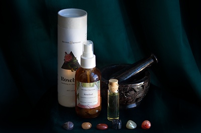 Items from a Herbalism and Ceremony subscription box including small colored stones, oils and fragrances.