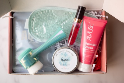 A box brimming with assorted self-care items intended for facial use. The contents include a range of products such as facial masks.