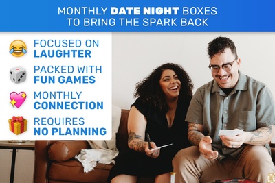 couple laughing on couch playing games from a date night subscription box focused on laughter, packed with fun games, connection