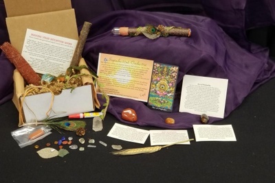 A Magickal Earth subscription box filled with magickal items including crystals, an astrological overview, and a tarot card.