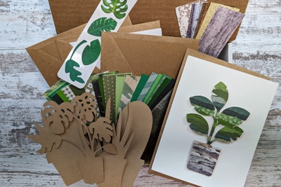 All the items in the September Torn Paper Art subscription box along with a completed houseplant mounted on a greeting card.
.