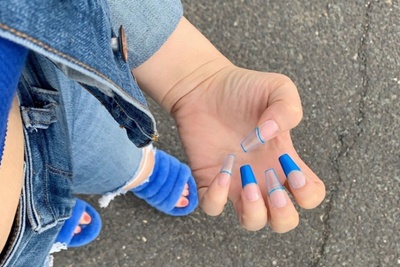 Set: Azure. Bold, bright blue french tip nails. Index and ring finger have filled in french tips. Other fingers have outline.
