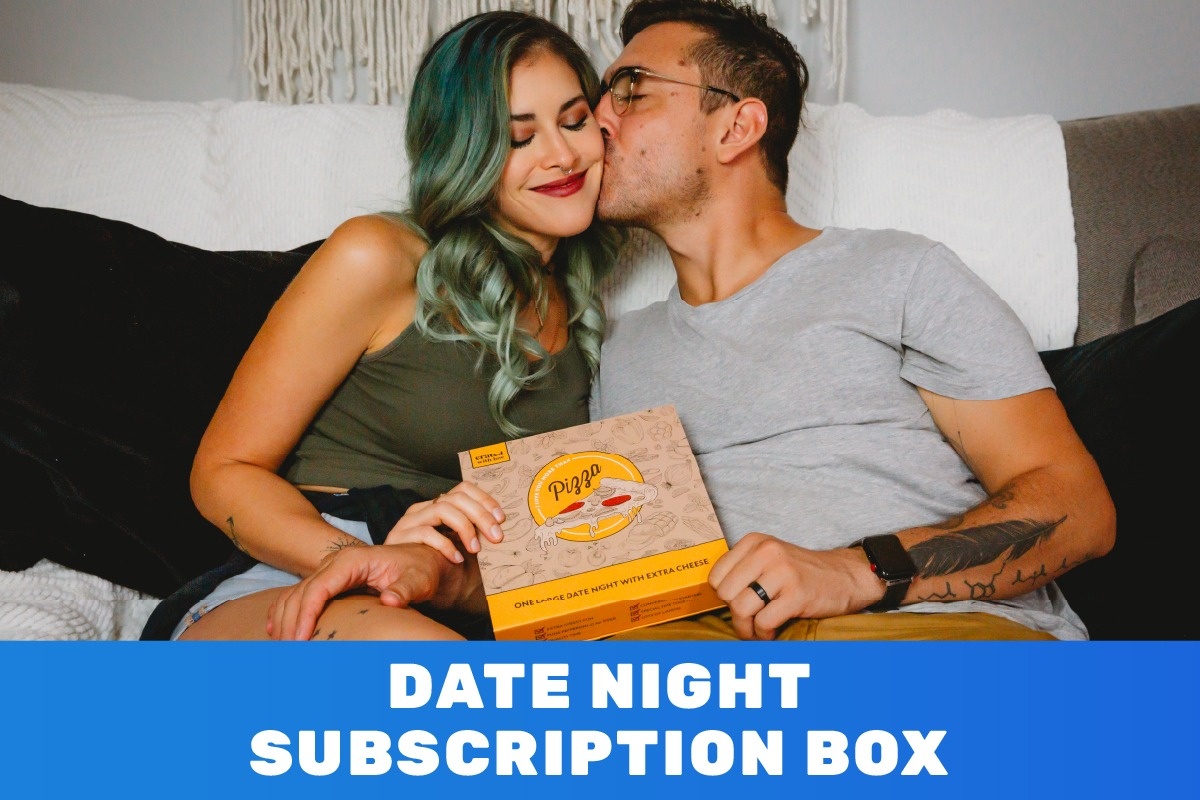 happy couple on couch laughing holding a date pizza themed night subscription box from crated with love