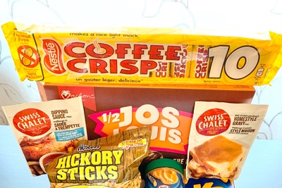 Items from a Canadian Snacks Food subscription box including hickory sticks, coffee crisp, homestyle gravy packet and more.