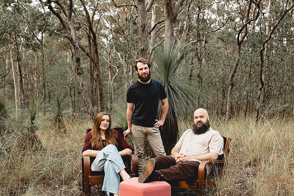 S.L-P Trio sitting in some bush area