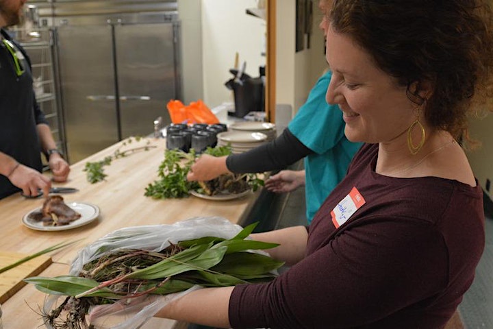 Wild Edibles participant holding some gathered ramps.