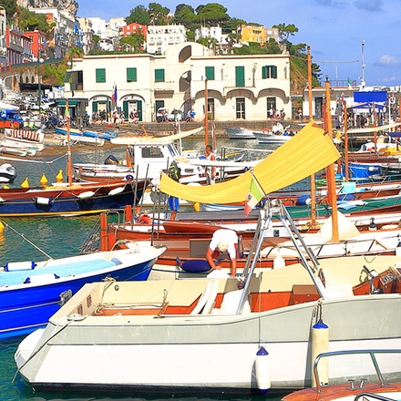Rows of boats docked on the harbour of the town of Marina Grande.