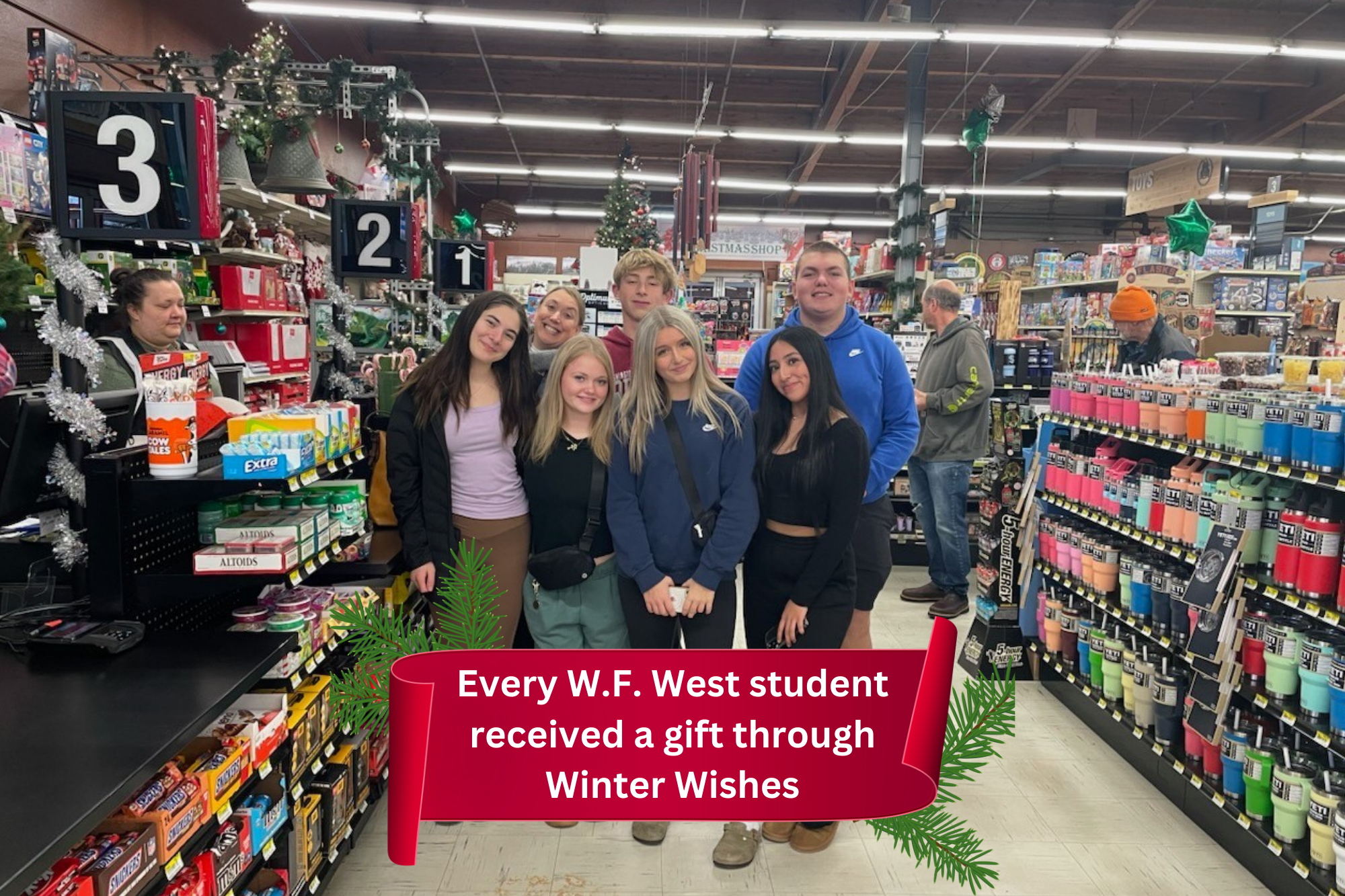 A group of W.F. Wes students and a teacher pose at the checkstand at Sunbirds while shopping for Winter Wishes gifts.