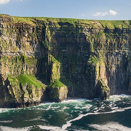 A view of the Cliffs of Moher in Ireland on a sunny day.