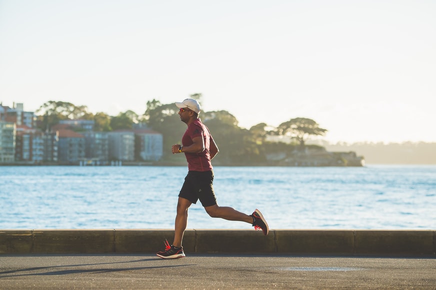 man running by the road