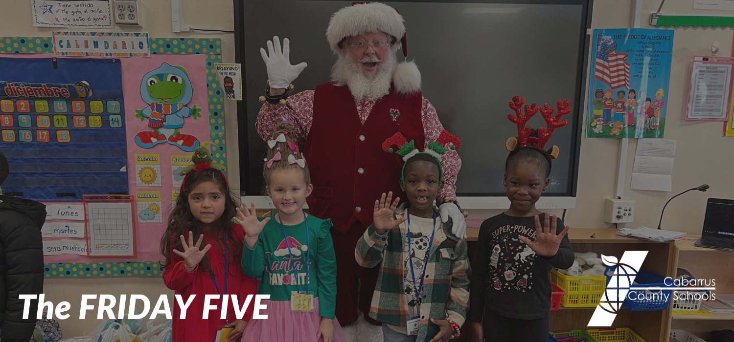 Four students and Santa holding up five fingers.