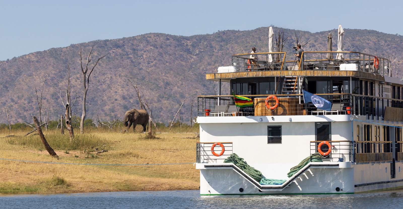 Nat Hab guest aboard the Zimbabwean Dream with elephant, Lake Kariba, Zimbabwe.