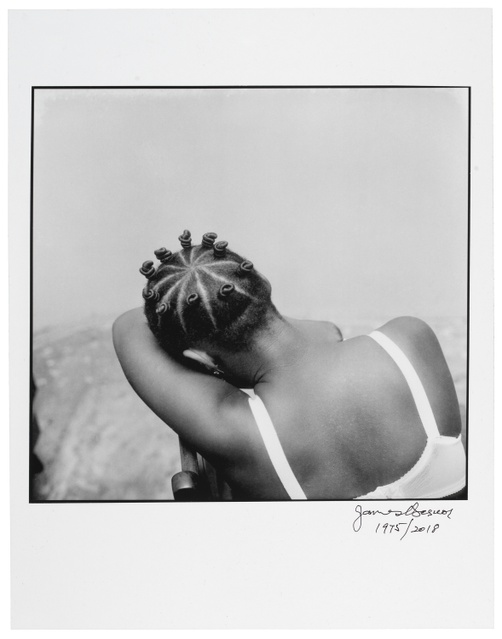 A black and white photograph of a young, Black girl with numerous braided buns with her head in the crook of her elbow resting on her knees.