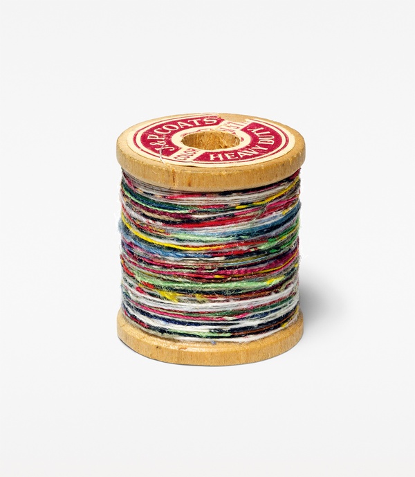 A small wooden spool wrapped with colorful thread.