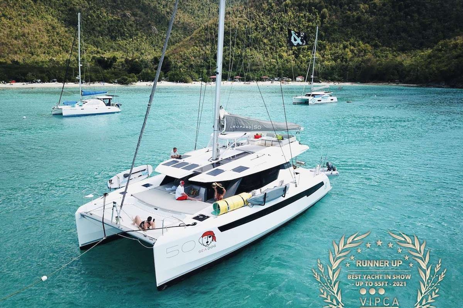                                                                                
                                   CHARTER BOAT OF THE YEAR - CRUISING WORLD
Lounging around on the flybridge a few steps removed from the helm station on a breezy afternoon in the Virgin Islands is pretty darned enjoyable. In fact so is strolling about the boat and taking in the expansive views from numerous vantage points. On this boat, the great outdoors literally pour into the saloon and sleeping cabins thanks to the wall of glass and overhead skylight that spans the saloon.It offers one master cabin with queen berth, lounge area, en-suite bath and equipped with TV and two  additional spacious queen cabins each with en-suite bath.