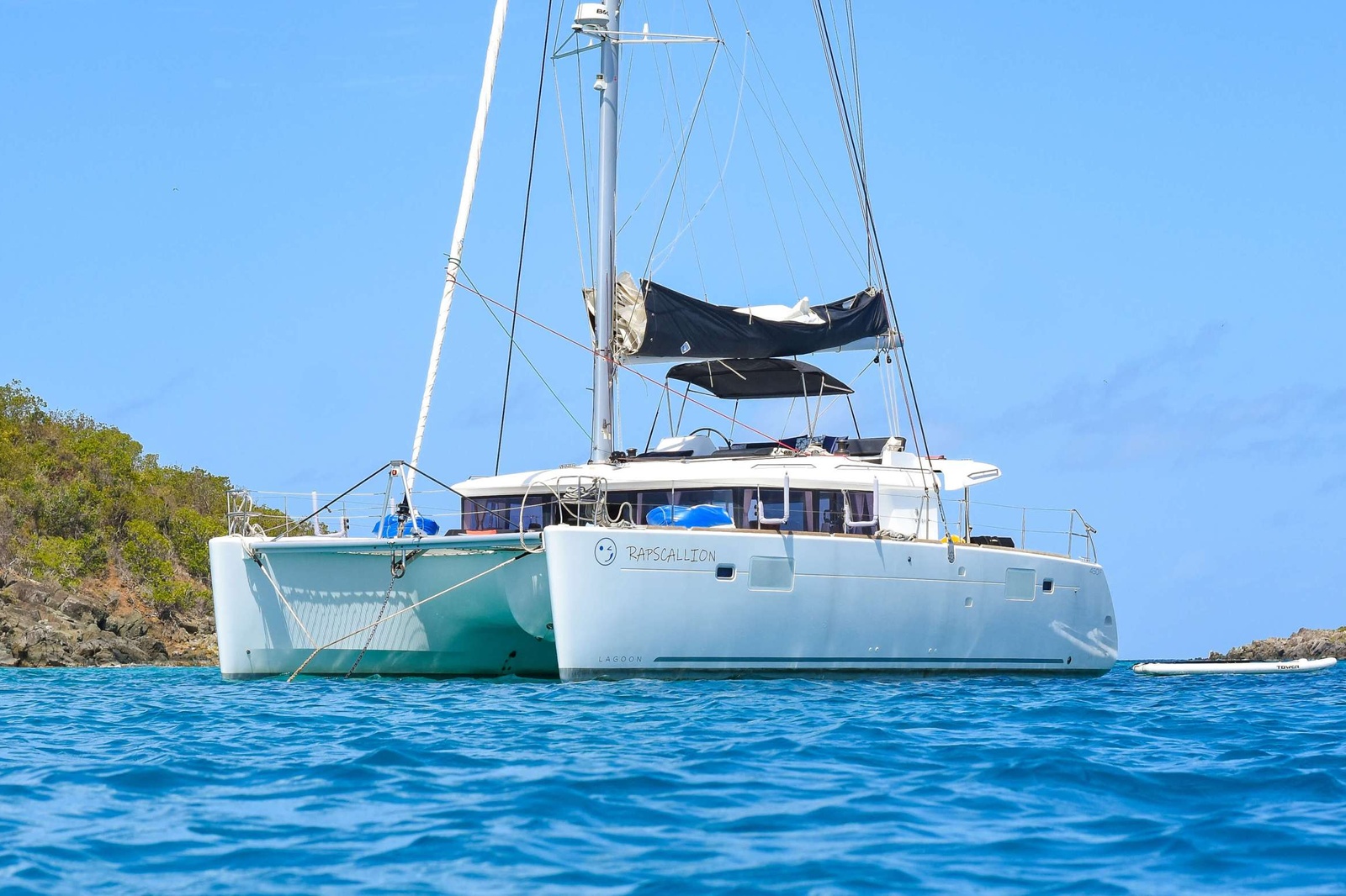 Rapscallion is a superb example of a 2018 45' Lagoon Catamaran with 3 queen cabins each with private ensuite baths including electric heads, vanity and separate showers. She boasts multiple areas for all 6 guests to sit and relax or sip a cocktail and enjoy the cool trade winds of the beautiful Virgin Islands! Furthermore, the salon has more than enough space for all guests to be comfortable for lounging or dining. The exterior aft deck also offers alfresco dining for 6 guests, top deck seating and a lounge area in front of the helm plus a forward lower deck lounge area behind trampolines. Water toys include snorkeling gear, floating mats, two stand-up paddleboards, and 2 fishing rods. Rapscallion and its award-winning crew offer nothing less than a charter of a lifetime!