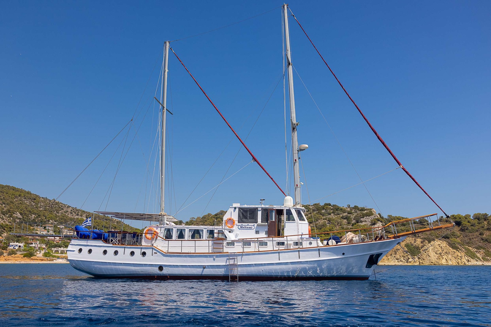 Side View of Meltemi anchored at a Greek beach