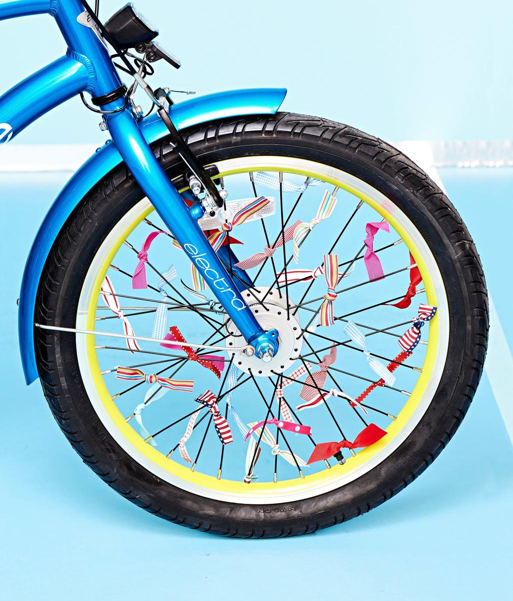ribbons attached to spokes of blue bike