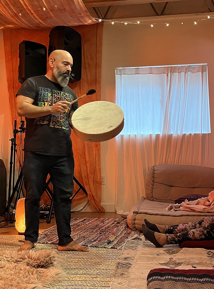 Breathwork facilitator Andy Rubiano drumming