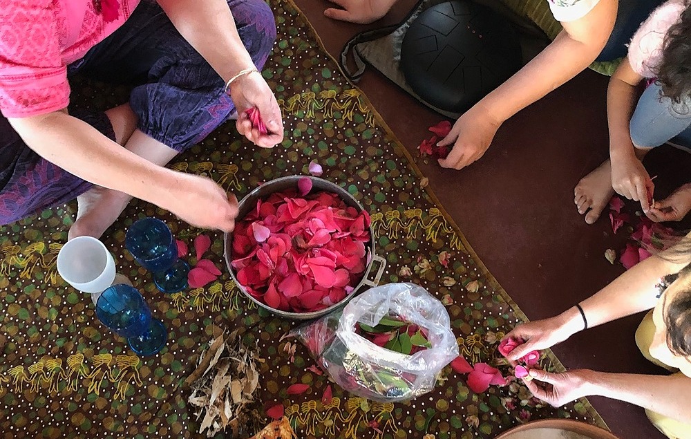 Making rose-petal beads a the opening ceremony