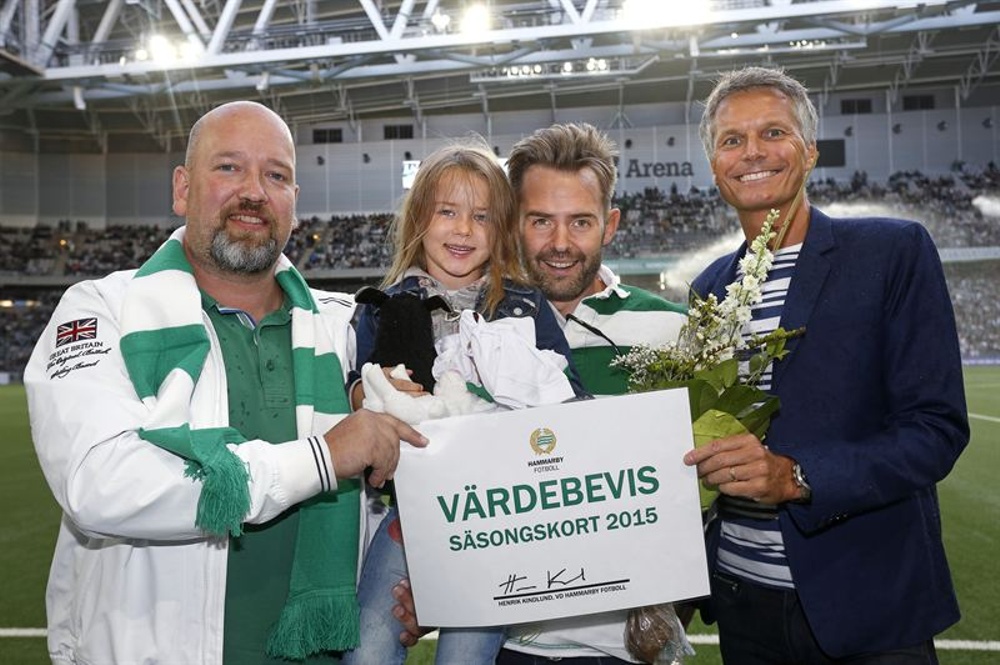 Henrik Kindlund, VD Hammarby Fotboll (till vänster) och Patrik Tengwall, Tele2 Arena ansvarig på Stockholm Globe Arenas (höger) firar Johan och dottern Adele som den miljonte besökaren på Tele2 Arena. 
