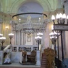 Silver memorial lamps hang before  the ark, which holds many torah scrolls from all of Alexandria's one-time synagogues.