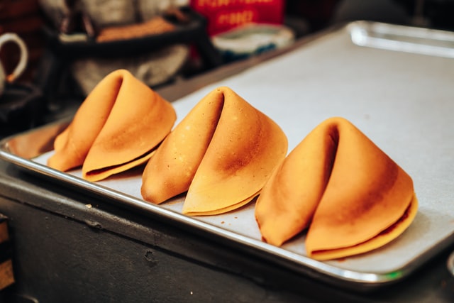 three fortune cookies on a tray