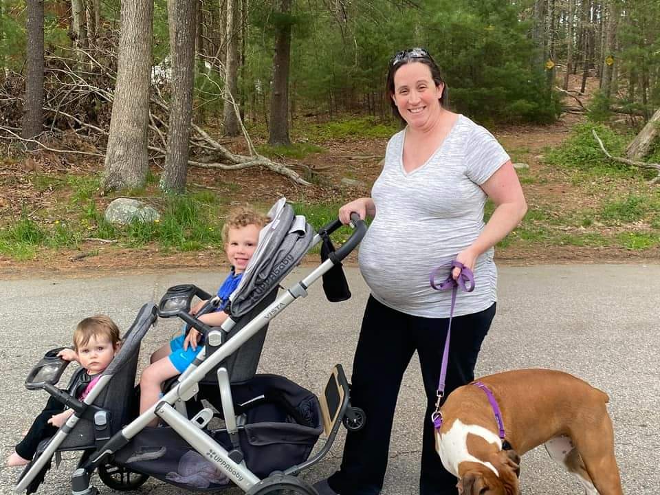 Mom and dog walking with kids in stroller