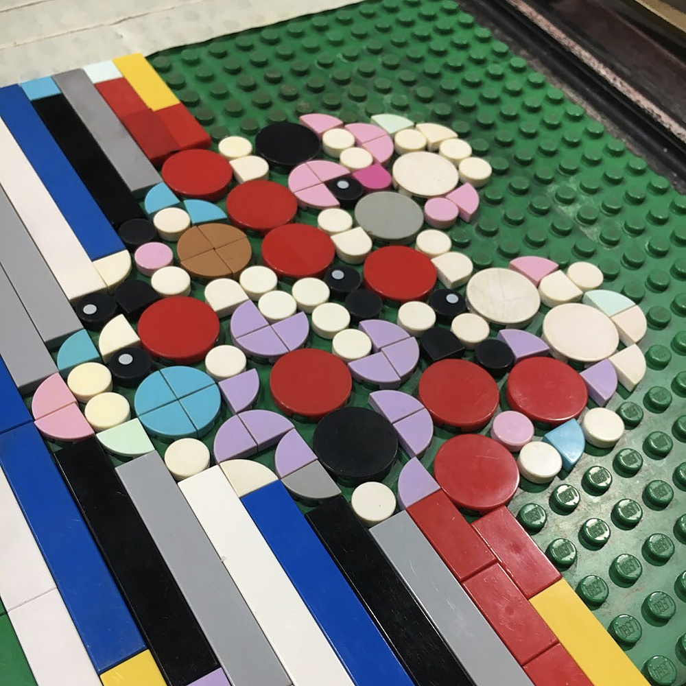 Close up of lego tiles on a base plate in a heart shape