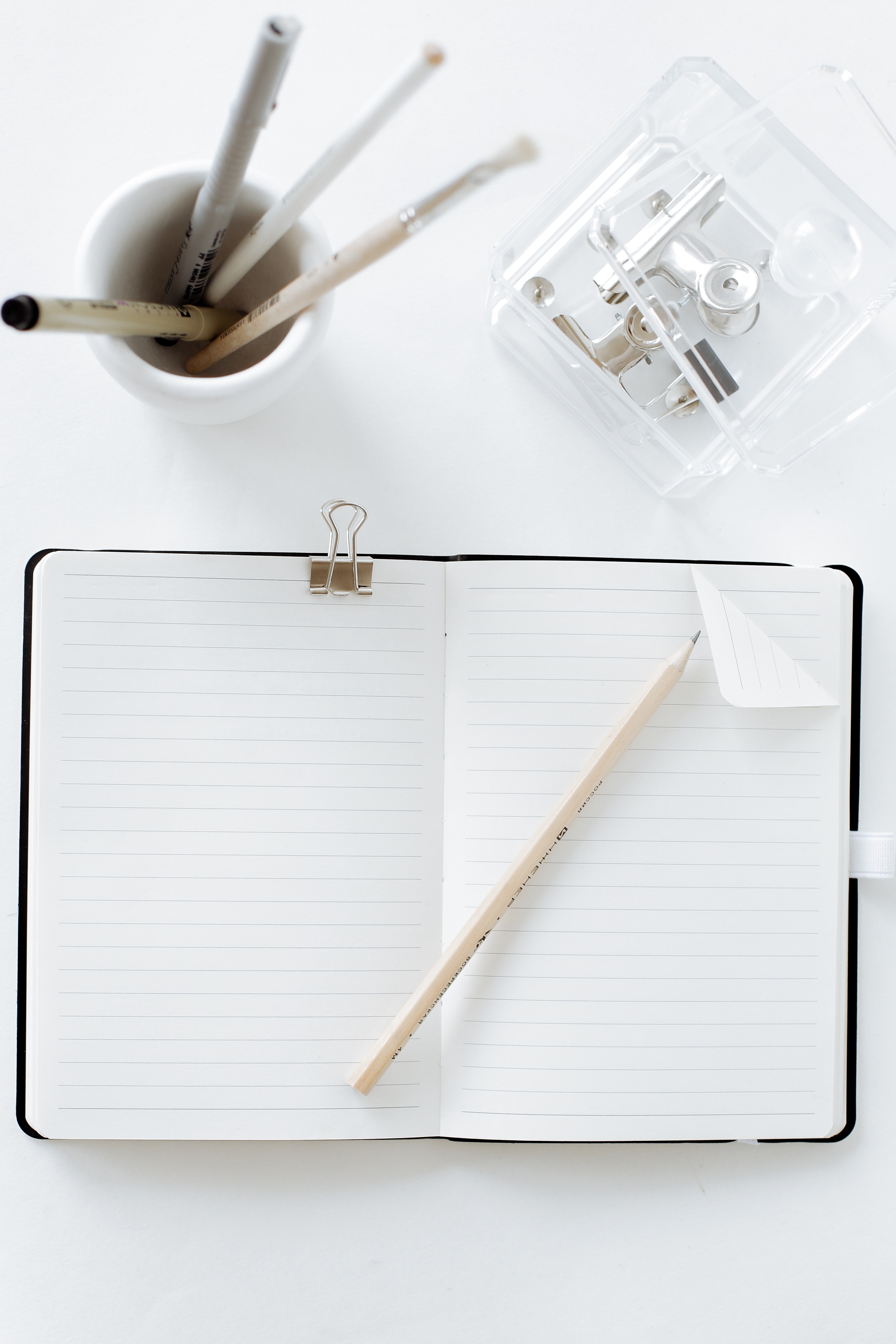 An empty notepad on a minimalistic desk