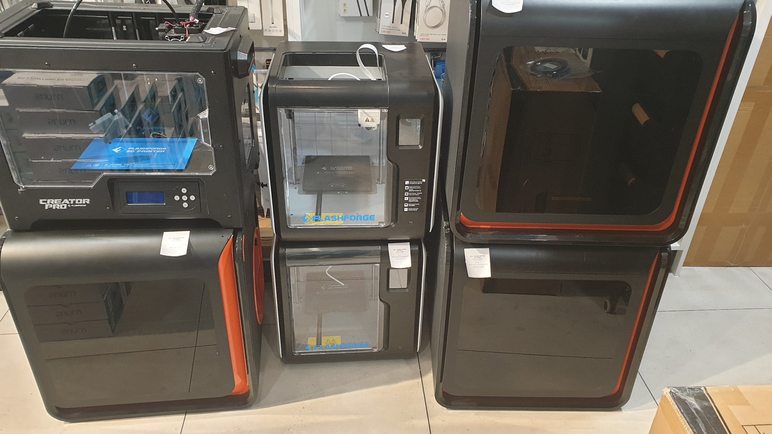 Multiple 3D printers shown, likely awaiting diagnostic checks and repairs.