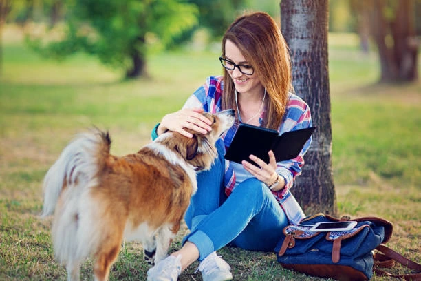 student enjoying a dogs company 