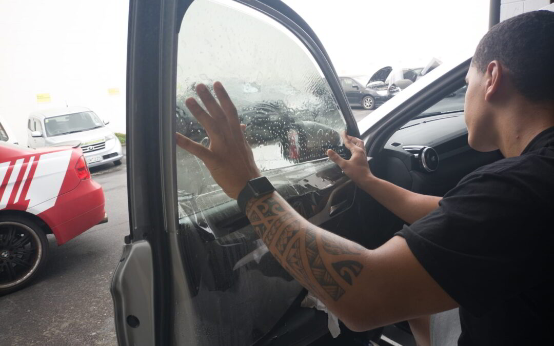 Professional Installer, installing car window tint in Rosedale New Zealand. High Quality Tint delivering a Quality Result
