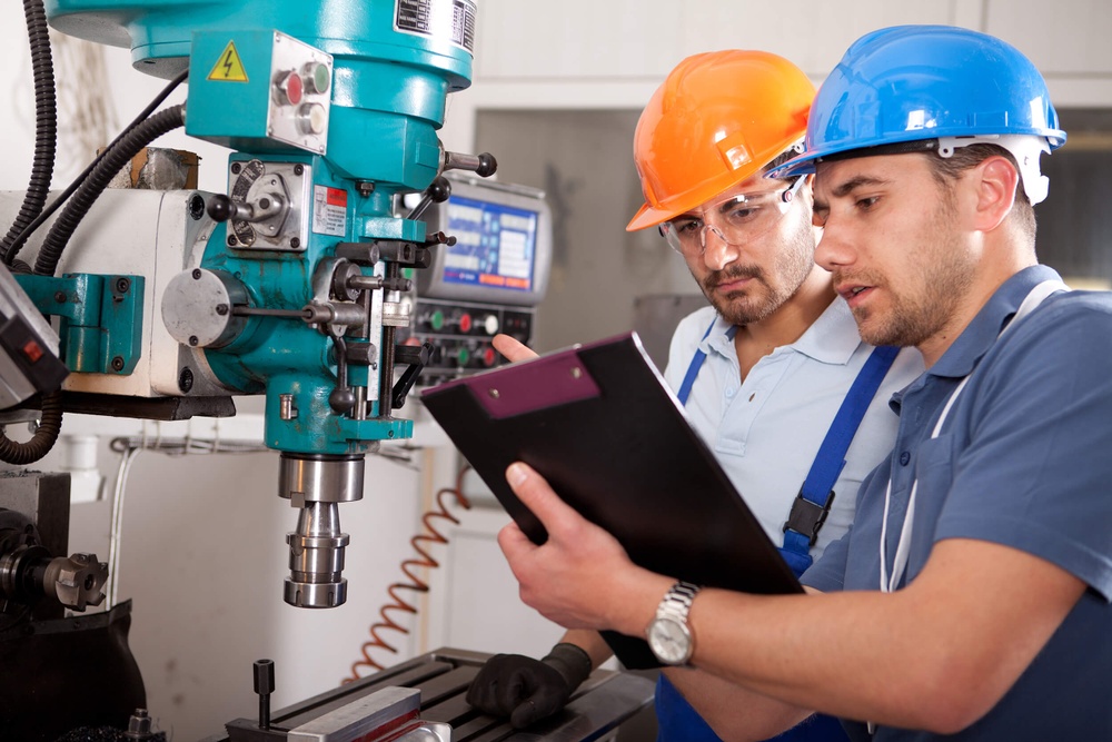 Machine operators checking a machine