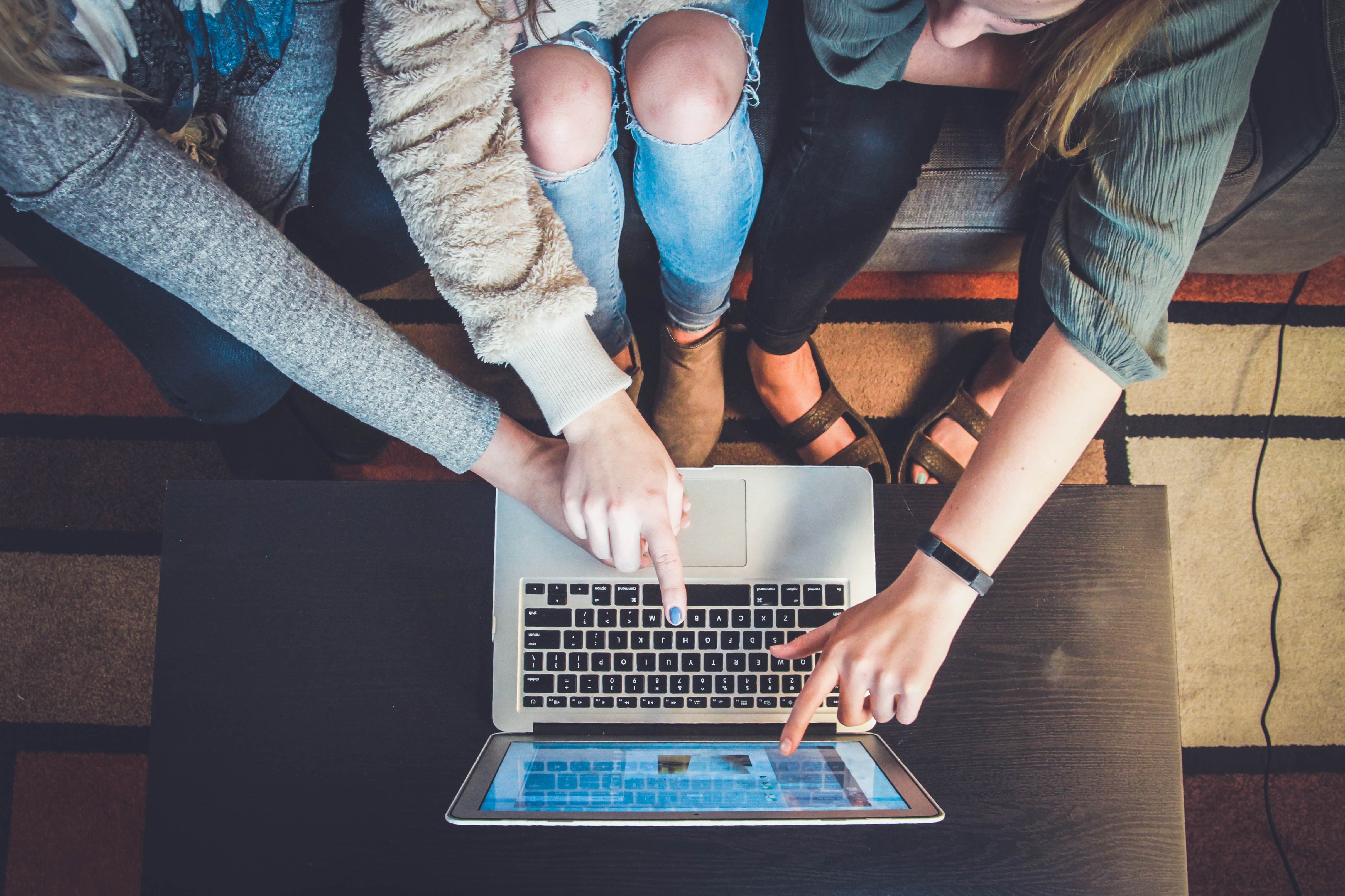 three people looking at their e-commerce store on a computer