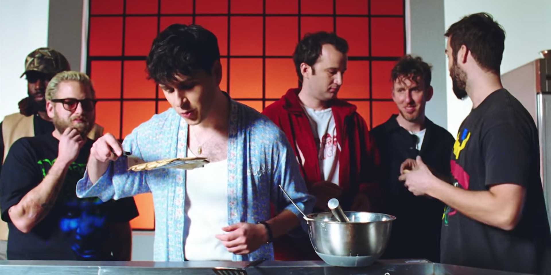 Vampire Weekend's Ezra Koenig flips pancakes masterfully for Jonah Hill and friends in music video for 'Harmony Hall' – watch 