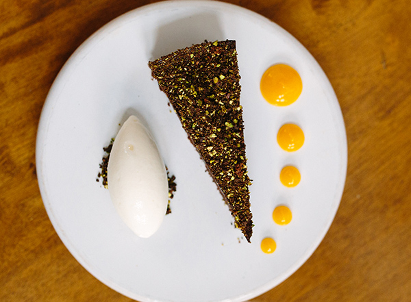 Dark chocolate tart, clementine purée, pistachio and yogurt sorbet