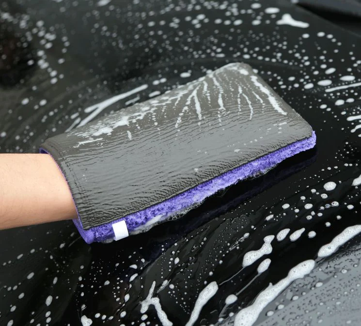 A Clay mitt used to remove stubborn surface contamination from the Black cars paintwork