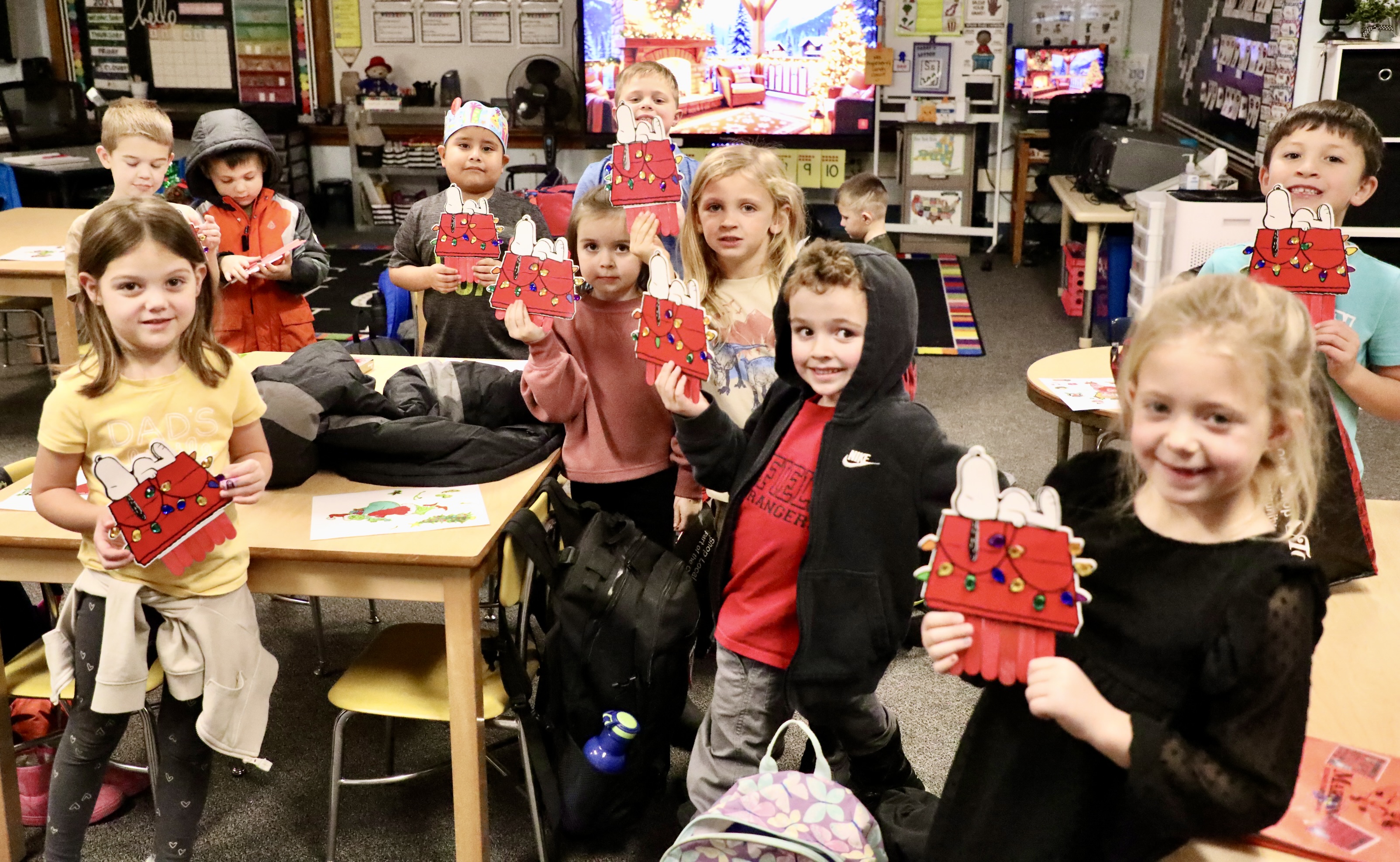 Students show off Snoopy Ornaments that were made in an after school Mini Camp on Thursday, Dec. 5.