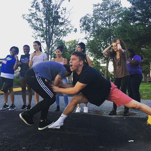 (Me on the left in Adidas Pants) (On right a friend I made) This picture was taken on the first day of Summer Scholars. This was one of the ice breaker activities we did. Goal was to get from one side to the next without touching the cement, only 4 tiles.