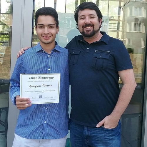 One of my instructors, Josh, and me holding a Certificate of Completion on the last day of the program.