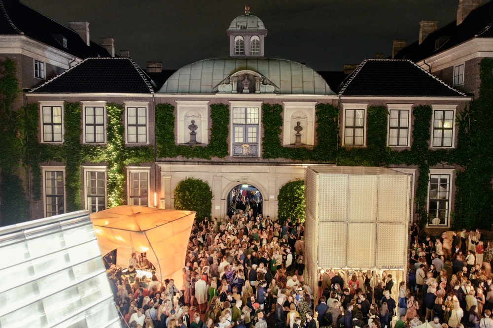 A crowd at an art event in the courtyard of a historic building during the art fair CHART in 2019. 