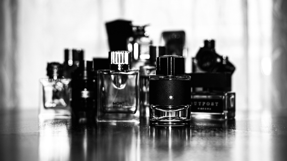 Black and white picture of men's cologne bottles.