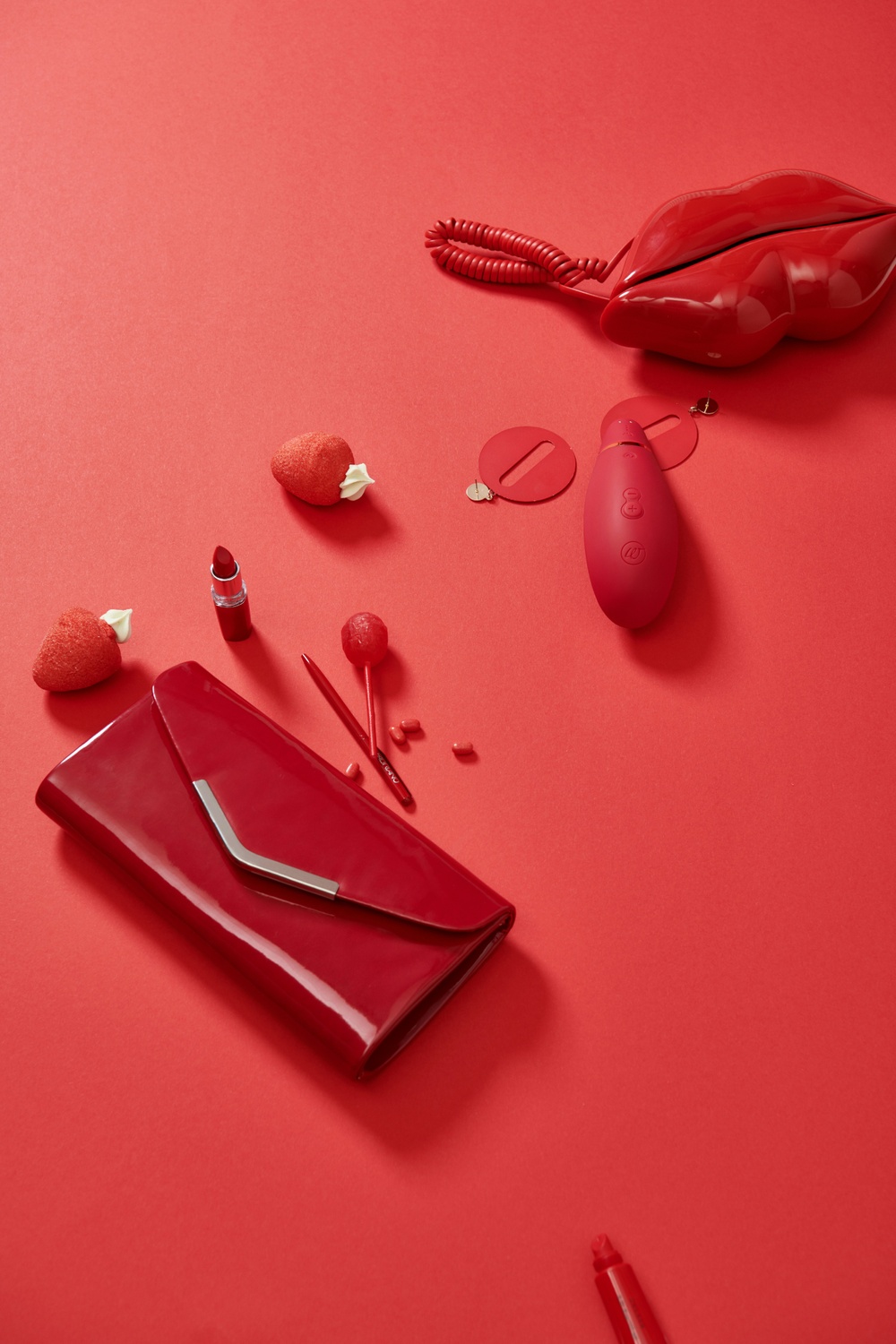 Red gifts and cosmetics on a red background