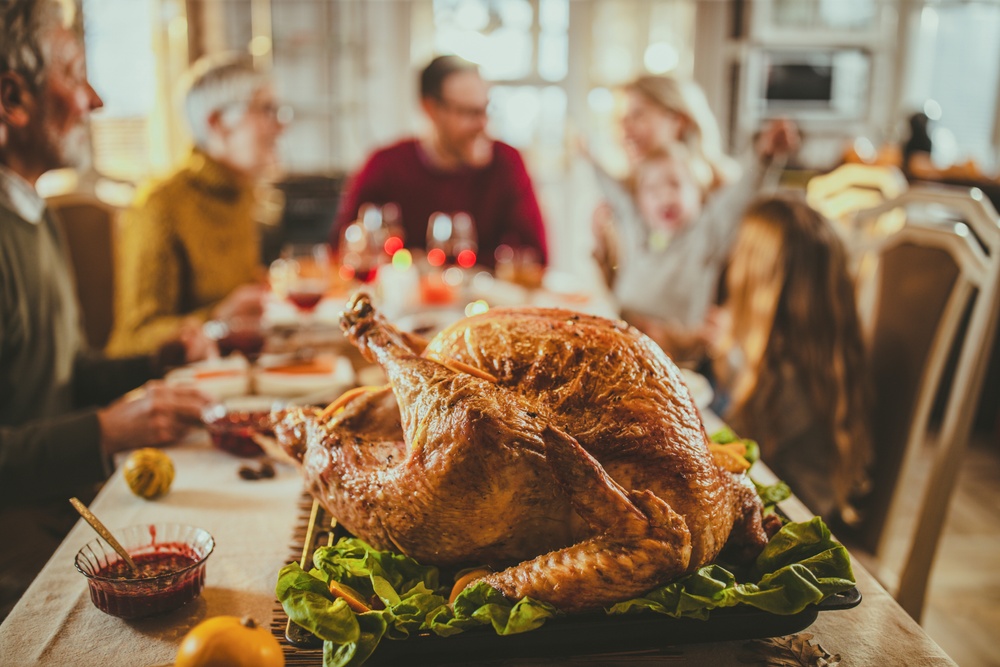 A family gathers for a delicious turkey dinner on Thanksgiving. 