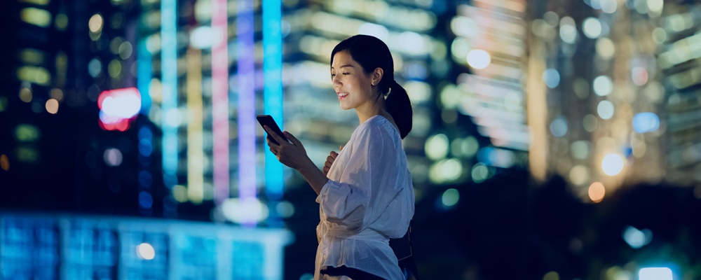 Woman in urban setting looking at her phone