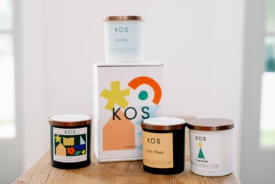 Four jar candles and a box from the Kos Candle Club subscription box.